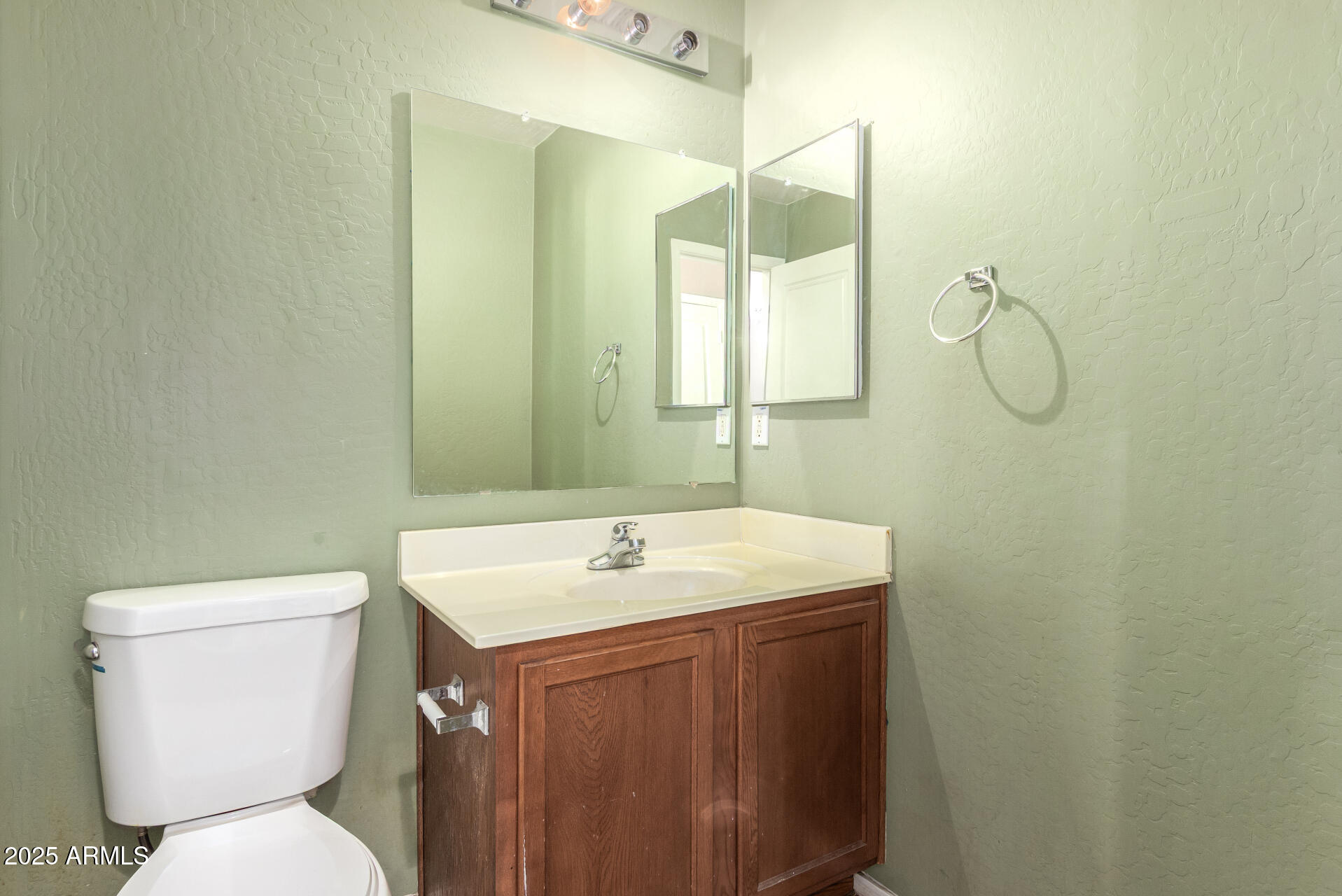 7229 West Crown King Road Phoenix, AZ 85043 - Photo 18 of 38 a bathroom with a toilet sink and mirror