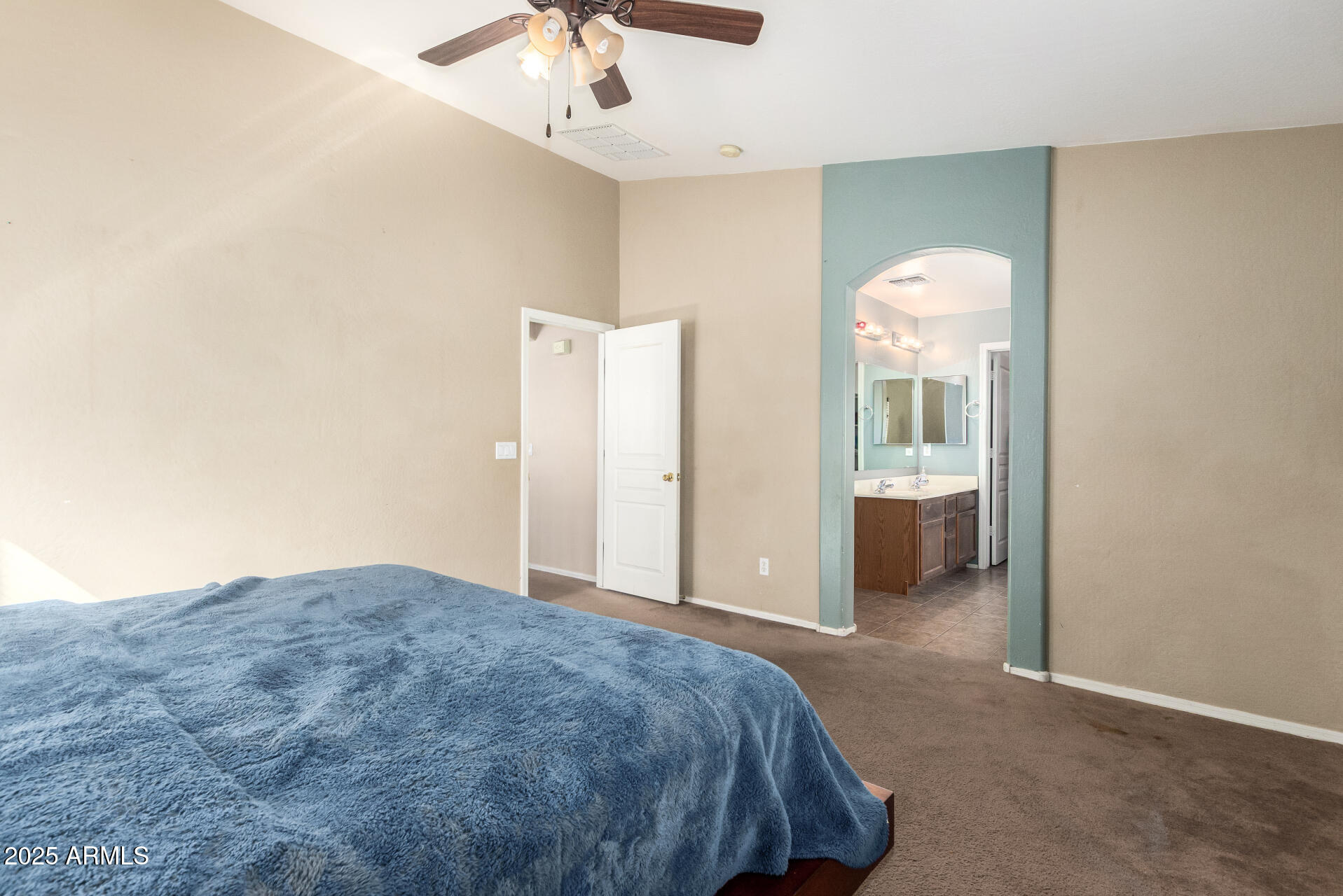 7229 West Crown King Road Phoenix, AZ 85043 - Photo 20 of 38 a spacious bedroom with a bed and a chandelier