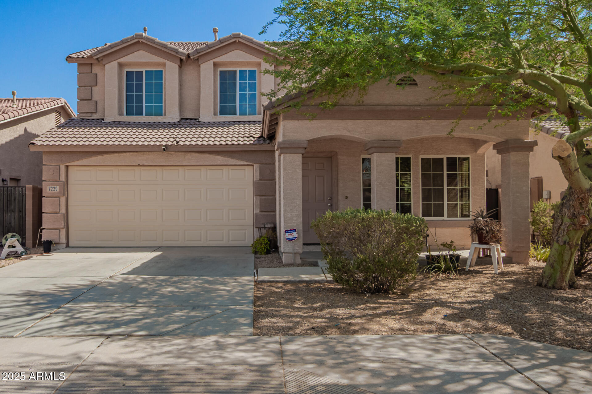 7229 West Crown King Road Phoenix, AZ 85043 - Photo 2 of 38 a front view of a house with garden