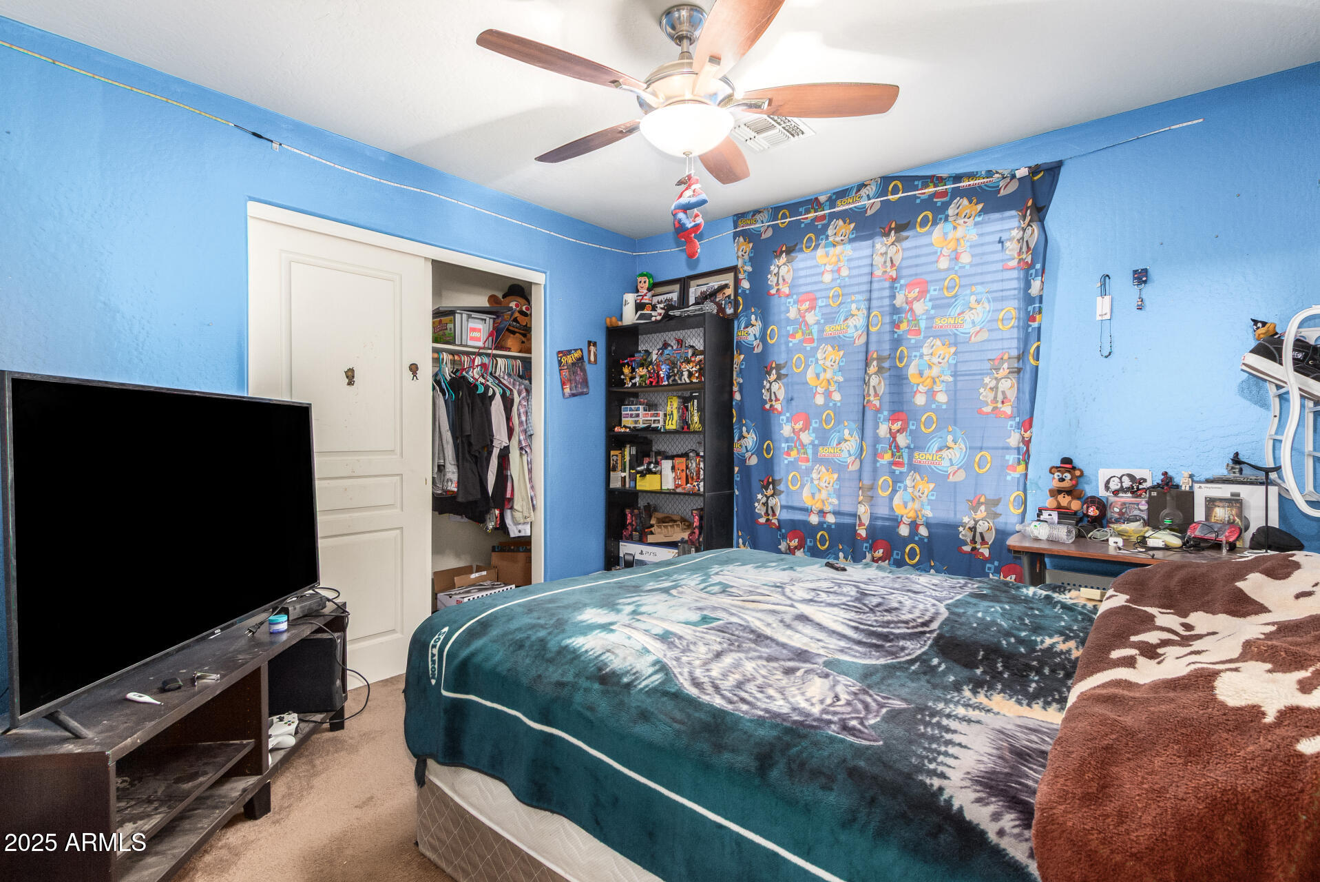 7229 West Crown King Road Phoenix, AZ 85043 - Photo 30 of 38 a bedroom with a bed and a flat screen tv