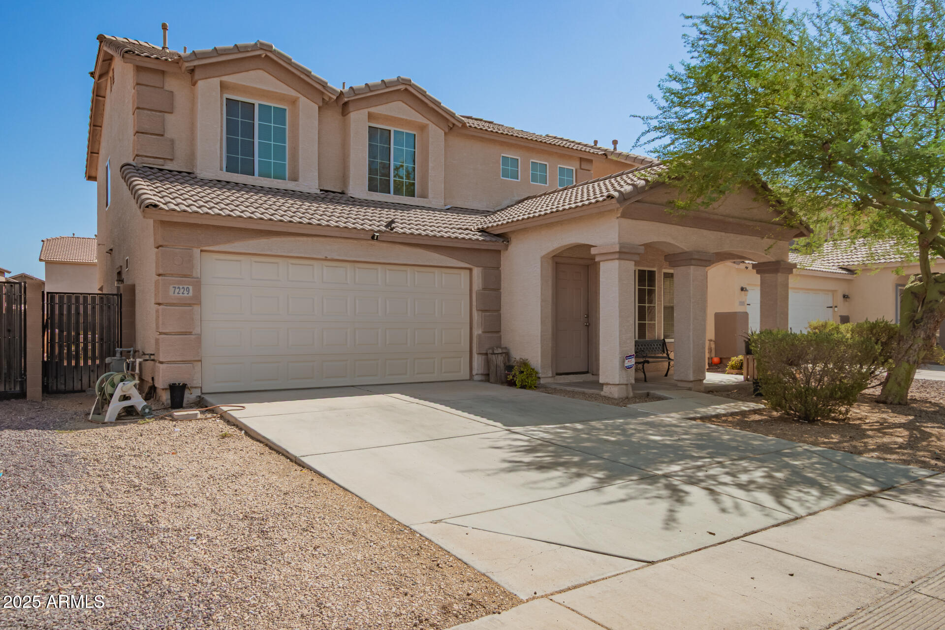 7229 West Crown King Road Phoenix, AZ 85043 - Photo 3 of 38 a front view of a house with a yard and garage