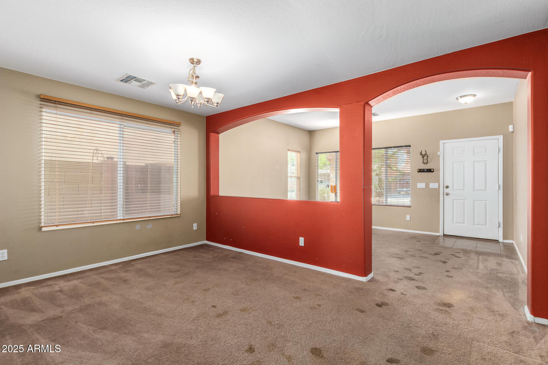 7229 West Crown King Road Phoenix, AZ 85043 - Photo 10 of 38 an empty room with chandelier and windows