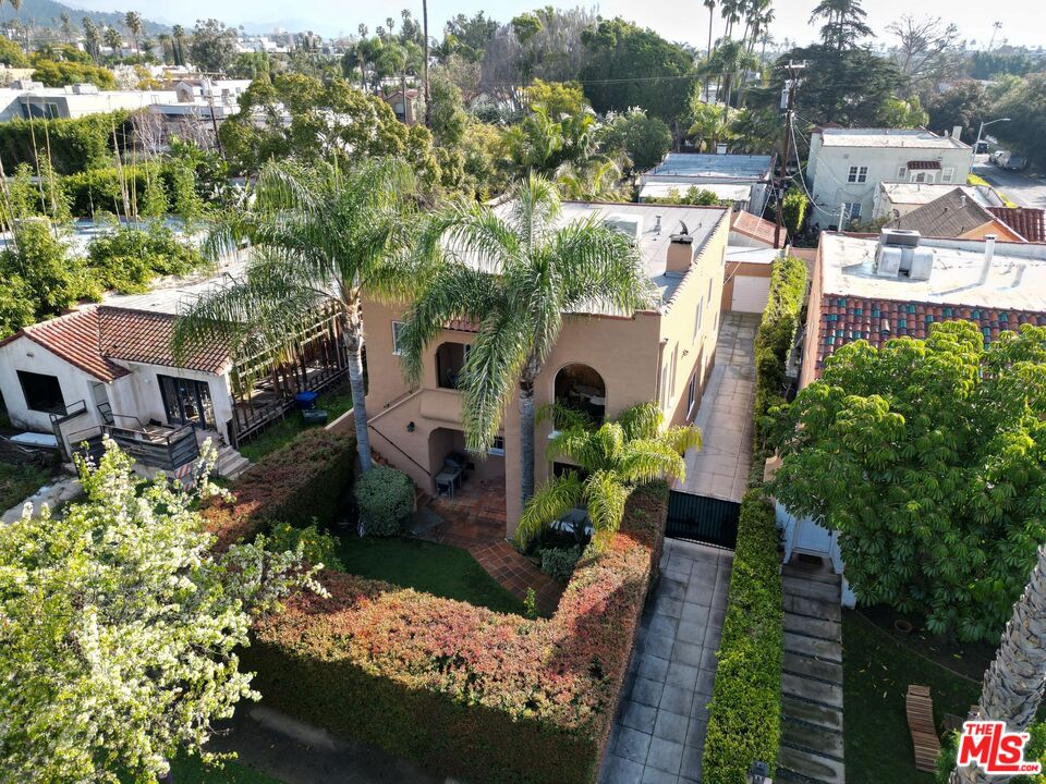 a aerial view of a house with a yard and plants