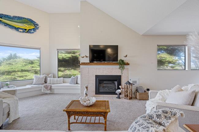 101 Shell Road, Unit 102 Watsonville, CA 95076 - Photo 13 of 34 a living room with furniture a fireplace and a flat screen tv
