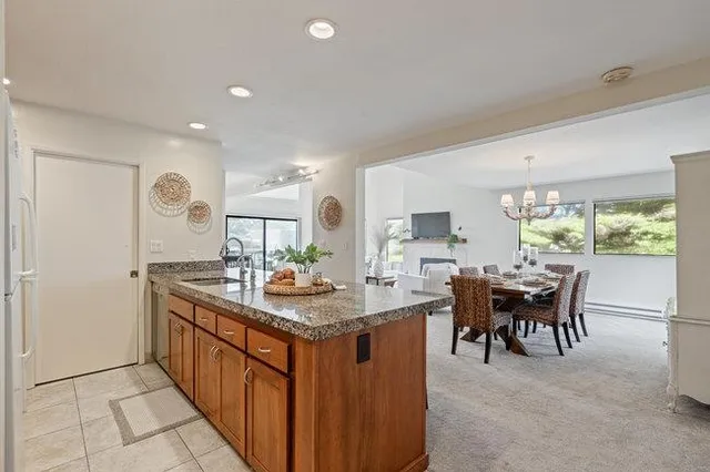 a kitchen with granite countertop a table and chairs in it