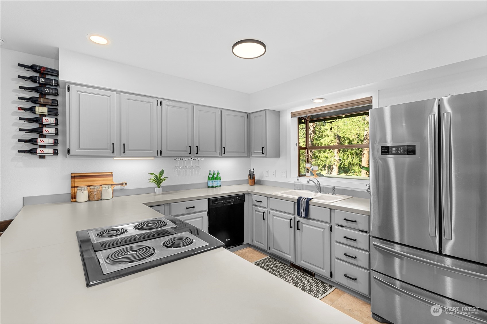 9151 Icicle Road, Unit E Leavenworth, WA 98826 - Photo 3 of 40 a kitchen with granite countertop a refrigerator stove top oven and sink