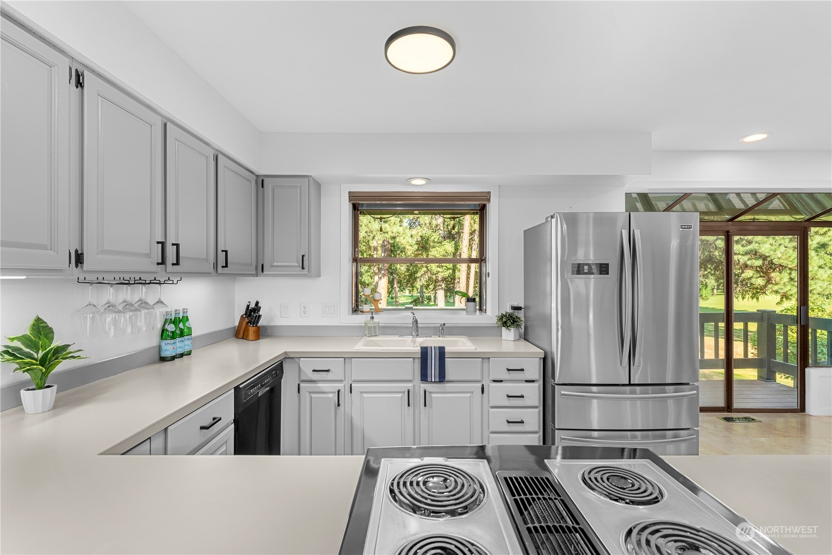 9151 Icicle Road, Unit E Leavenworth, WA 98826 - Photo 5 of 40 a kitchen with stainless steel appliances granite countertop a sink stove and cabinets