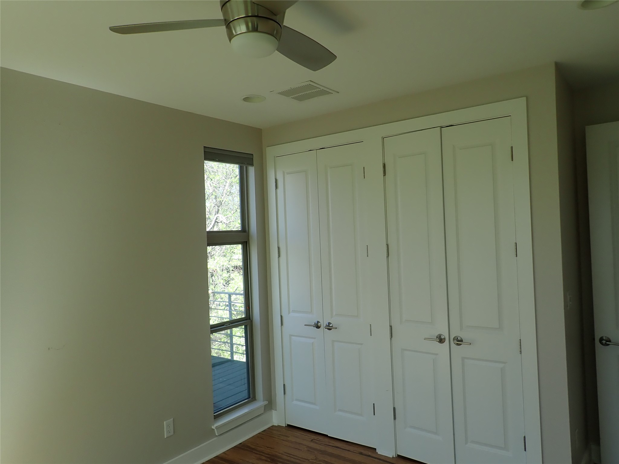 2912 East 14th Street, Unit A Austin, TX 78702 - Photo 15 of 27 Primary Bedroom featuring wood finished floors and ceiling fan
