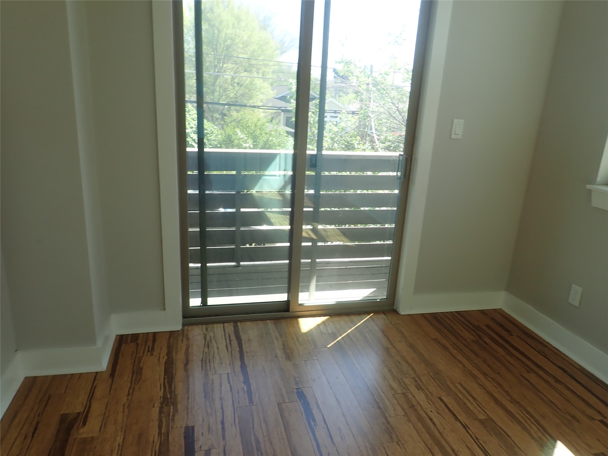 2912 East 14th Street, Unit A Austin, TX 78702 - Photo 25 of 27 Bedroom with baseboards and dark wood-type flooring