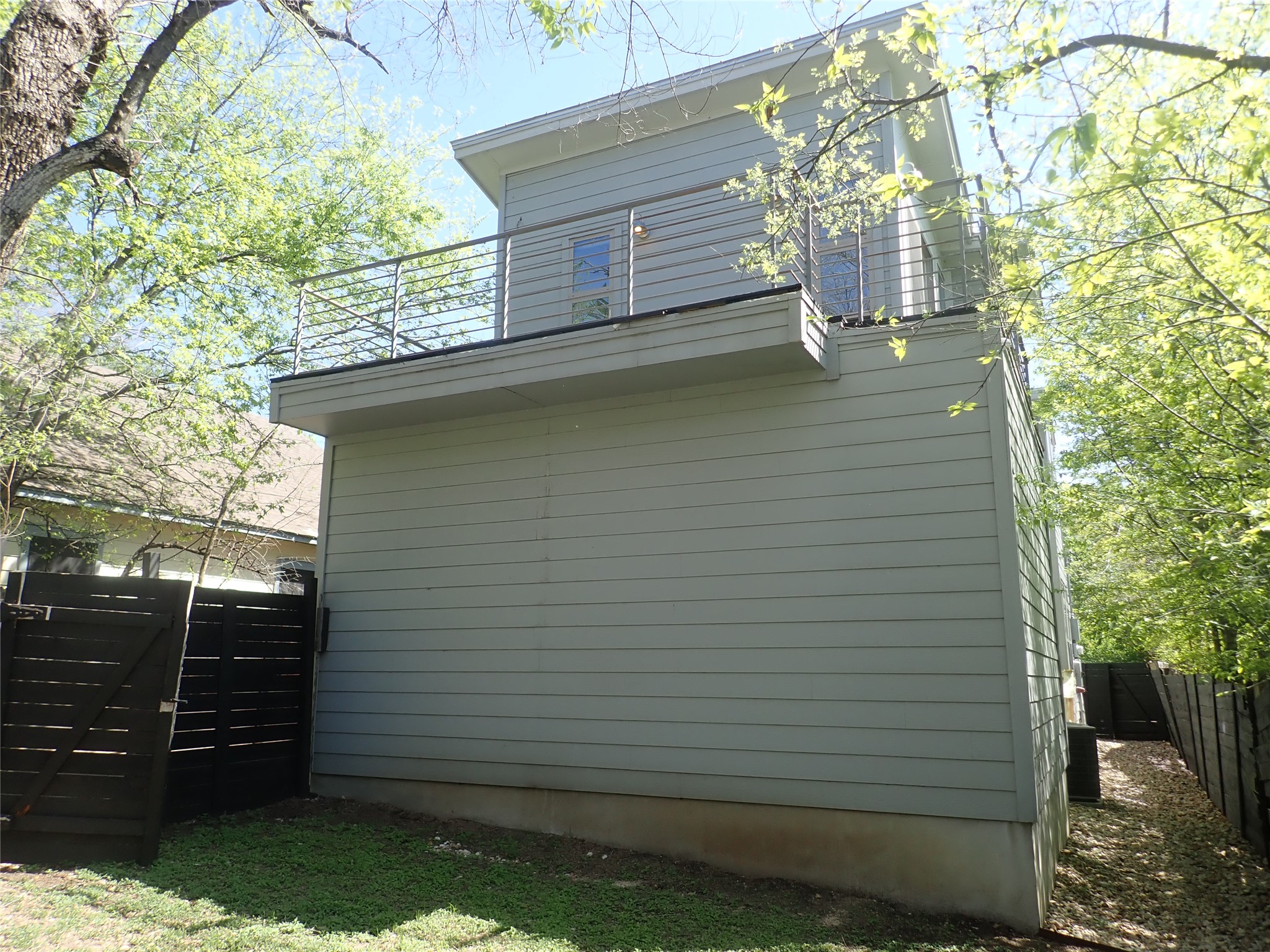2912 East 14th Street, Unit A Austin, TX 78702 - Photo 4 of 27 View of property exterior with a gate and a balcony