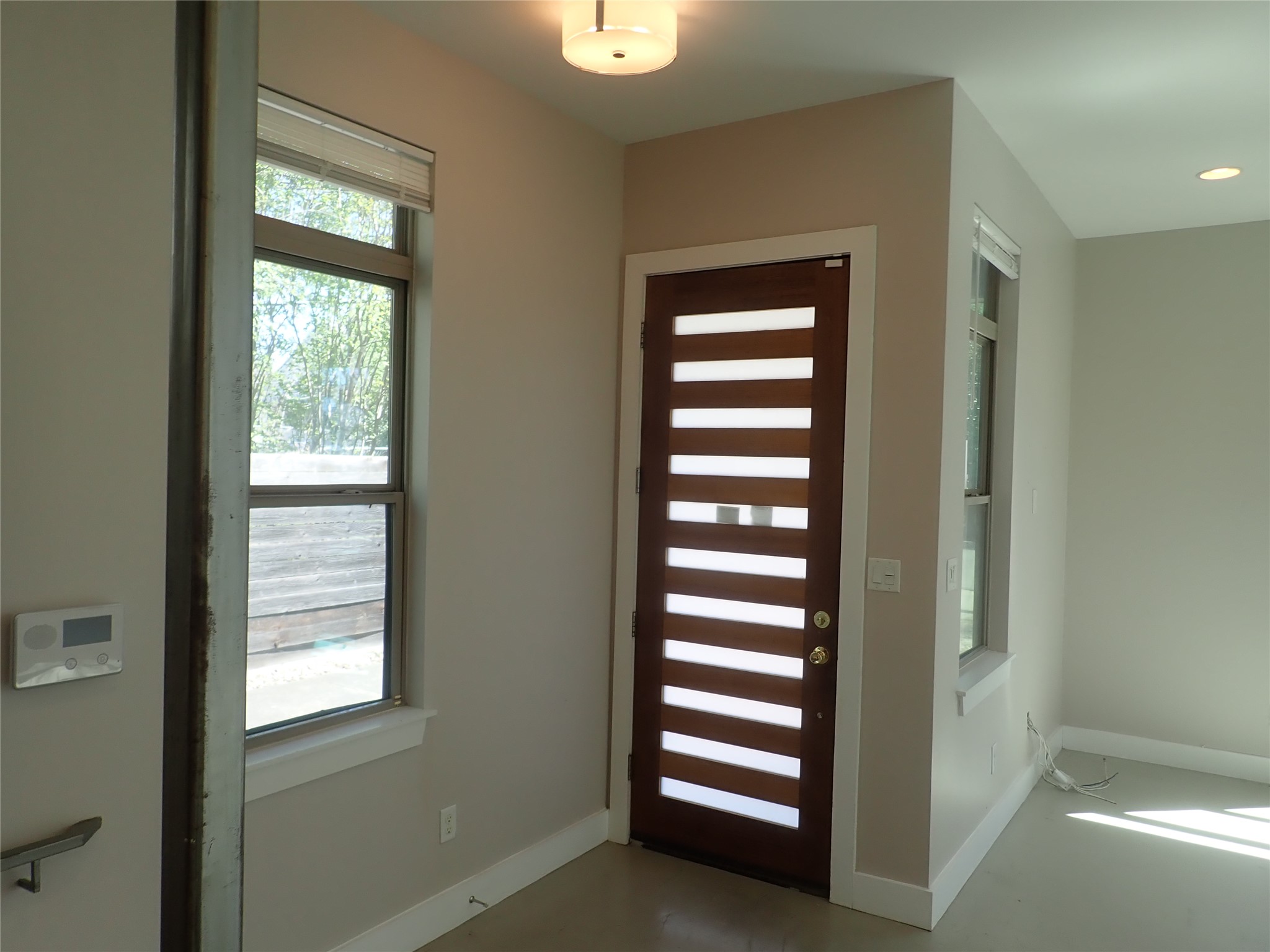 2912 East 14th Street, Unit A Austin, TX 78702 - Photo 6 of 27 Entryway with baseboards and concrete flooring