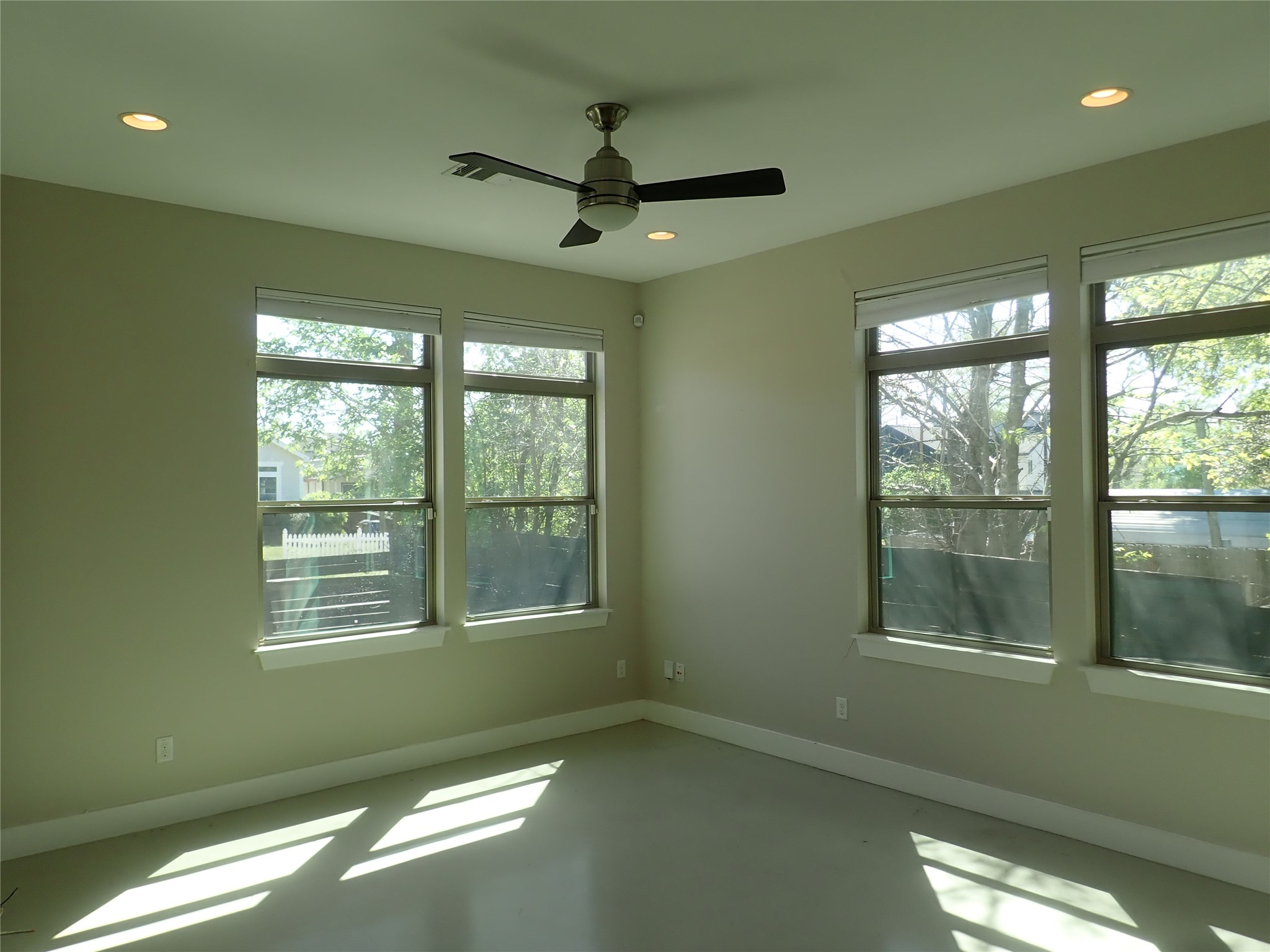 2912 East 14th Street, Unit A Austin, TX 78702 - Photo 7 of 27 Living room featuring concrete floors, a ceiling fan, and recessed lighting