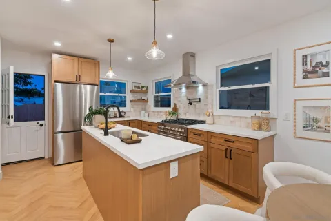 a kitchen with stainless steel appliances granite countertop a sink stove and refrigerator
