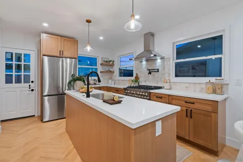 a kitchen with stainless steel appliances granite countertop a sink stove and refrigerator