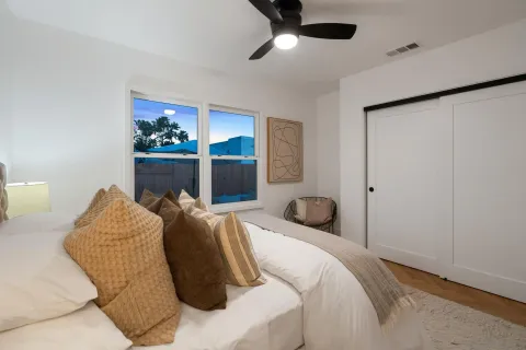 a bedroom with a bed and a painting on the wall