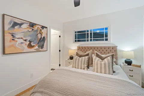 a view of a bedroom with baby bed and a window
