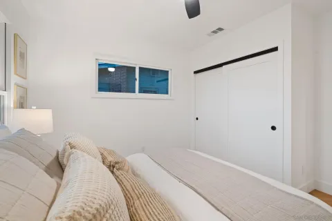 a bedroom with a bed and a wall painting