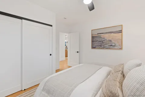 a bedroom with a bed and a painting on the wall