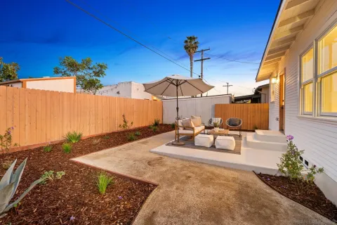 a view of a patio with a table and chairs