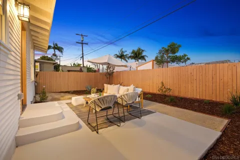 a view of a patio with a table and chairs