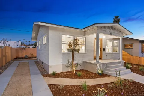 a view of a hall with wooden floor and a rug