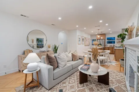a living room with furniture and a wooden floor
