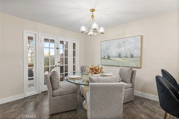a kitchen with a refrigerator a stove a sink and white cabinets