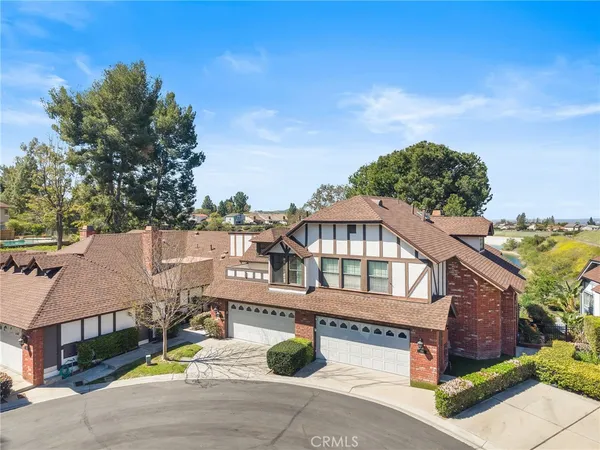an aerial view of a house with a street
