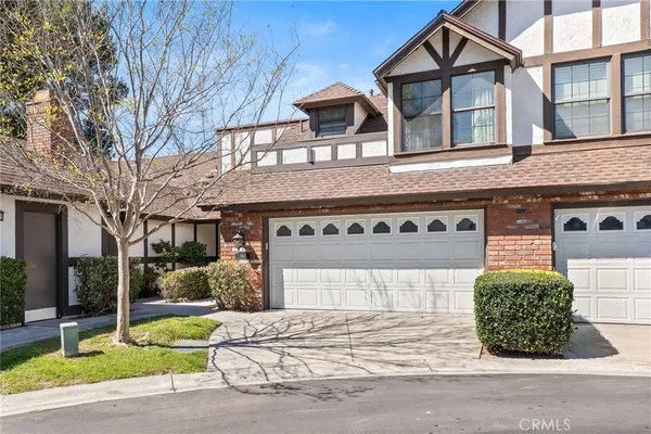 a front view of a house with a garden and garage