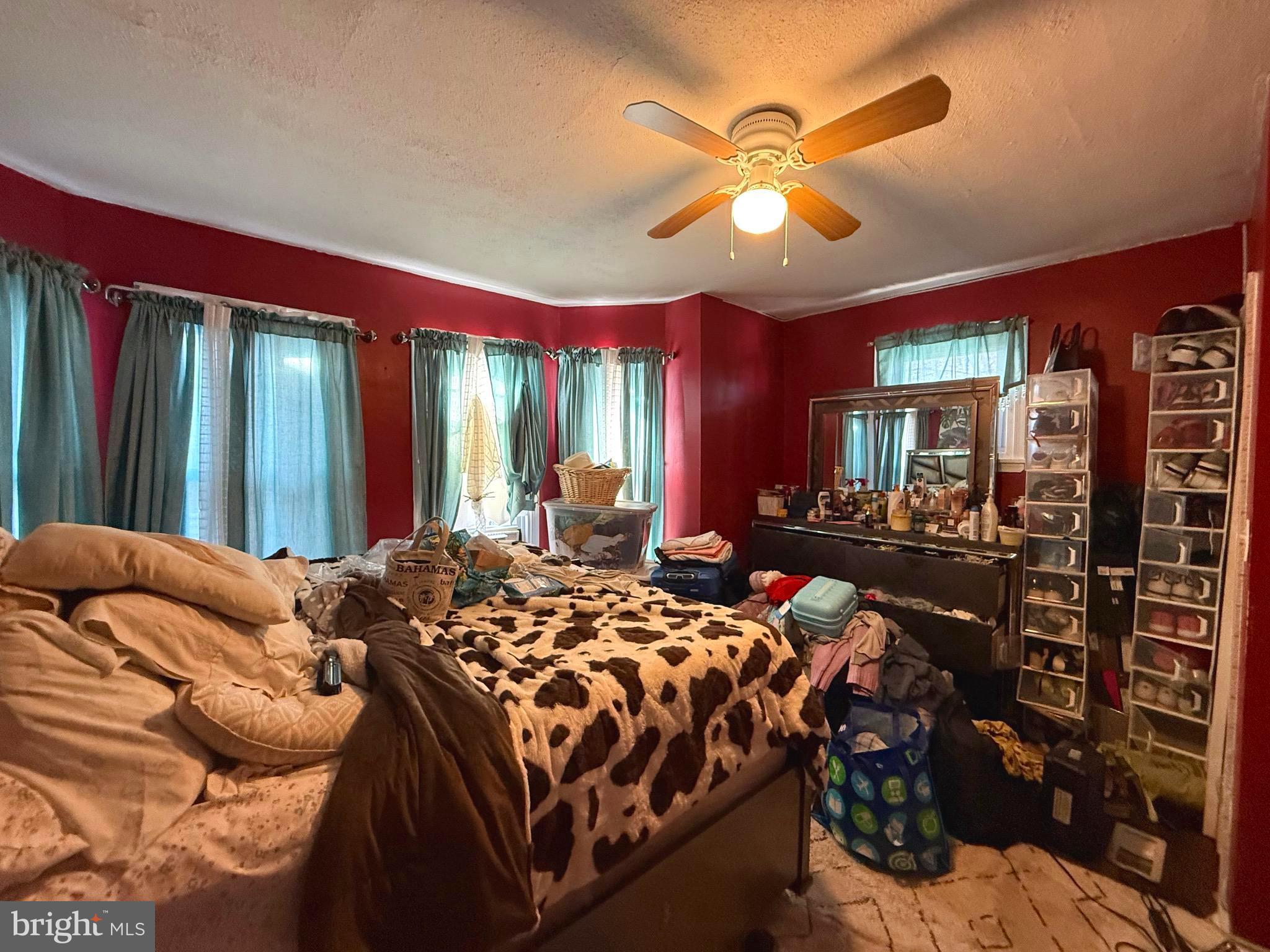 212 North Maple Avenue Lansdowne, PA 19050 - Photo 12 of 29 a bedroom with a bed ceiling fan and a large mirror on the dresser