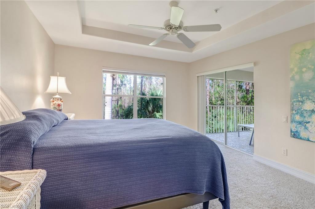 849 Carrick Bend Circle, Unit 202 Naples, FL 34110 - Photo 12 of 20 a bed sitting in a bedroom next to a window