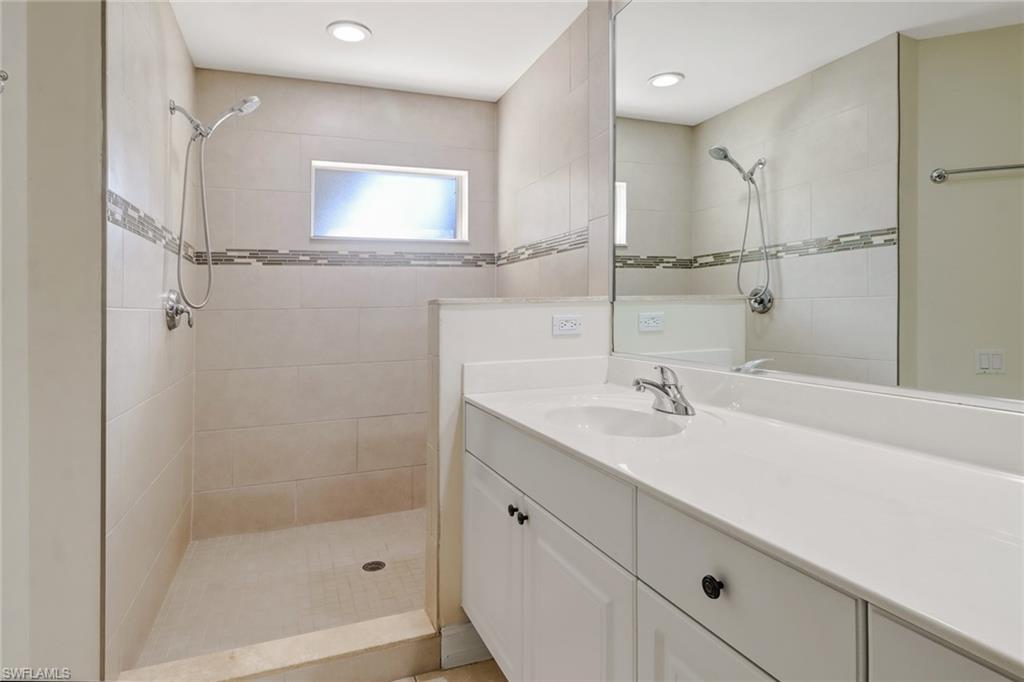 849 Carrick Bend Circle, Unit 202 Naples, FL 34110 - Photo 14 of 20 a bathroom with a sink and a mirror