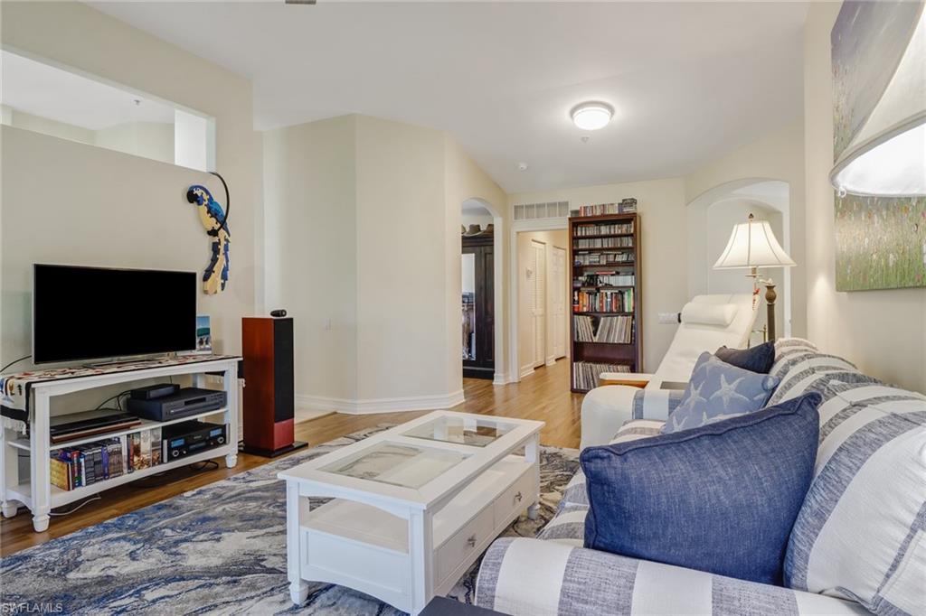 849 Carrick Bend Circle, Unit 202 Naples, FL 34110 - Photo 3 of 20 a living room with furniture and a flat screen tv