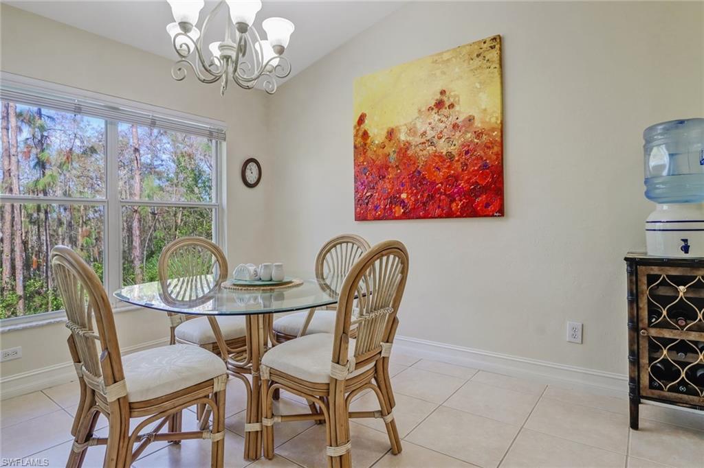 849 Carrick Bend Circle, Unit 202 Naples, FL 34110 - Photo 4 of 20 a view of a dining room with furniture chandelier and a window