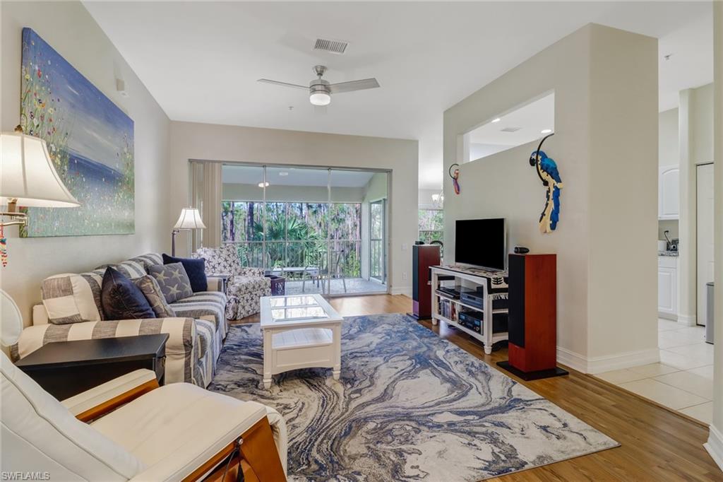 849 Carrick Bend Circle, Unit 202 Naples, FL 34110 - Photo 8 of 20 a living room with furniture and a flat screen tv