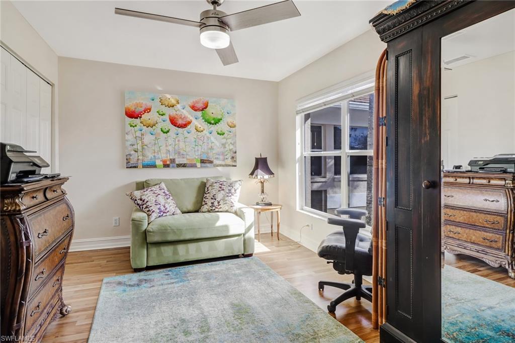 849 Carrick Bend Circle, Unit 202 Naples, FL 34110 - Photo 10 of 20 a living room with furniture and a window
