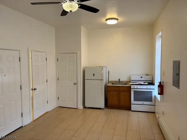 a kitchen with a stove and a refrigerator