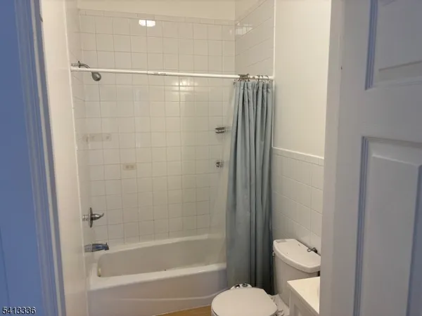 a bathroom with a shower and a toilet
