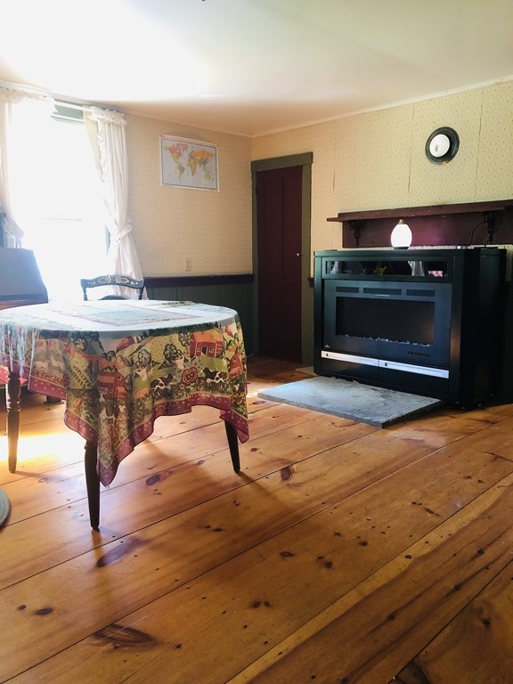 1007 Petersham Road Hardwick, MA 01037 - Photo 24 of 33 a living room with a fireplace furniture and a flat screen tv