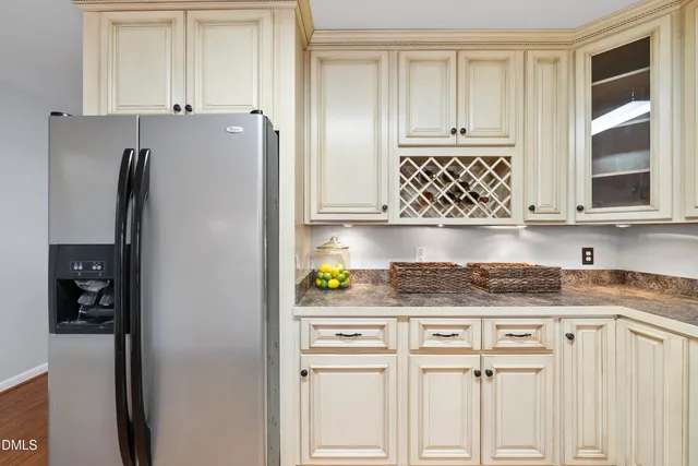 a bedroom with a large bed a chandelier and a window