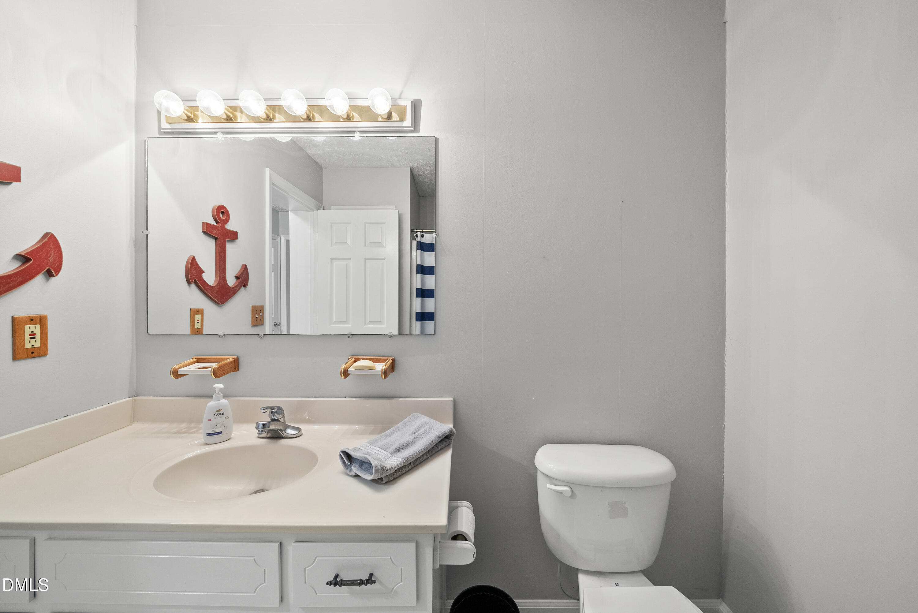 303 Hidden Hills Road Roxboro, NC 27574 - Photo 30 of 39 a bathroom with a sink mirror and toilet