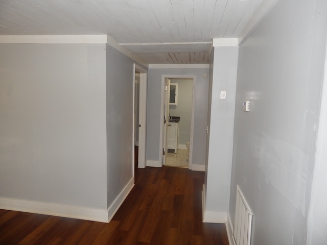 177 Seneca Creek Road Seneca, SC 29678 - Photo 11 of 26 This interior hallway features rich hardwood flooring leading to a well-appointed bathroom.