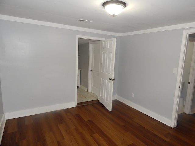 177 Seneca Creek Road Seneca, SC 29678 - Photo 14 of 26 This inviting bedroom features rich hardwood flooring and classic crown molding, offering comfort and style.