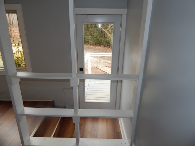 177 Seneca Creek Road Seneca, SC 29678 - Photo 21 of 26 This interior staircase offers a graceful transition between floors, leading to a bright exterior view.