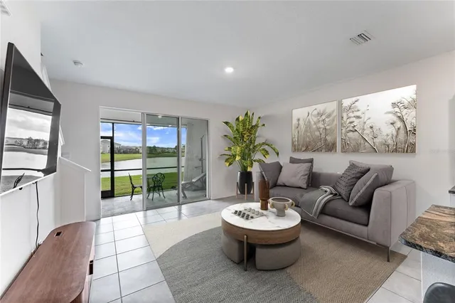 a living room with furniture and a potted plant