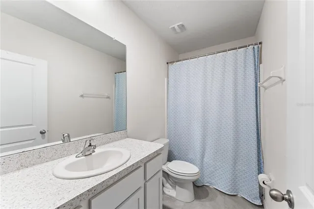 a bathroom with a sink toilet and a mirror