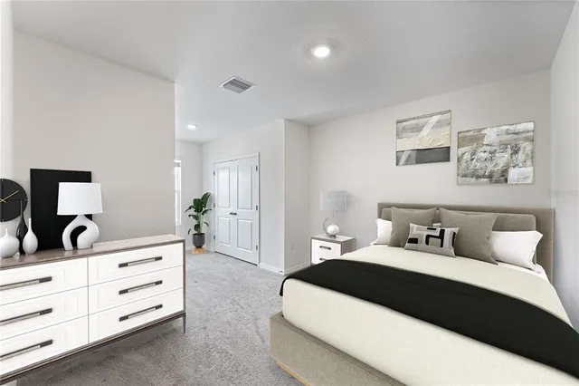 a bedroom with a large bed and a dresser