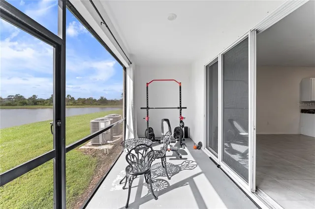 a view of a balcony with lake view and a large window