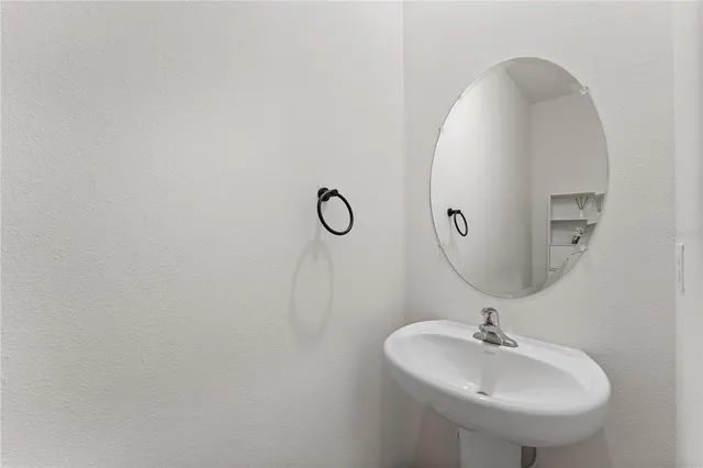 a bathroom with a sink and mirror