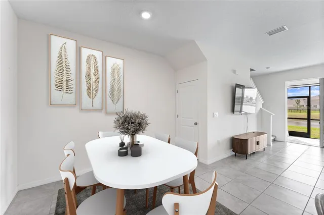 a view of a dining room with furniture and chandelier